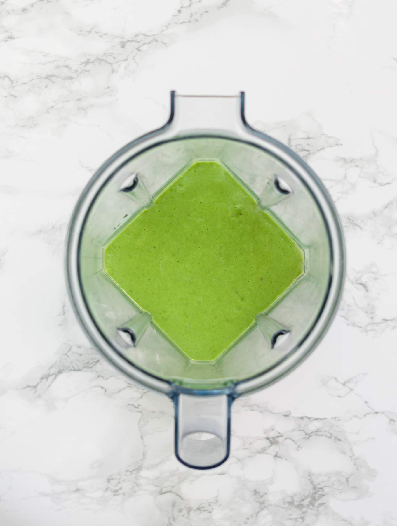 Blended green smoothie in blender