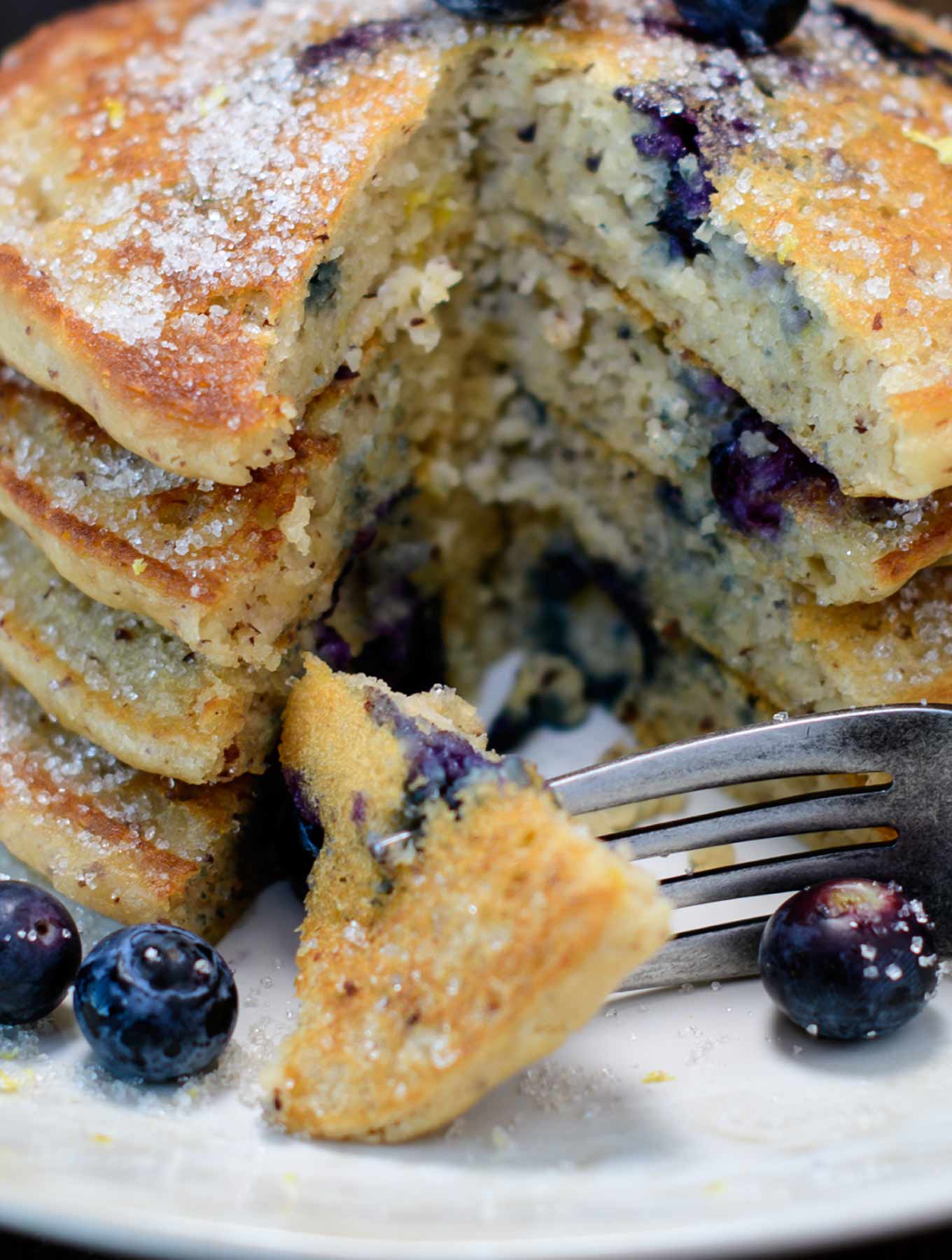 Stack of gluten free lemon blueberry pancakes with a fork