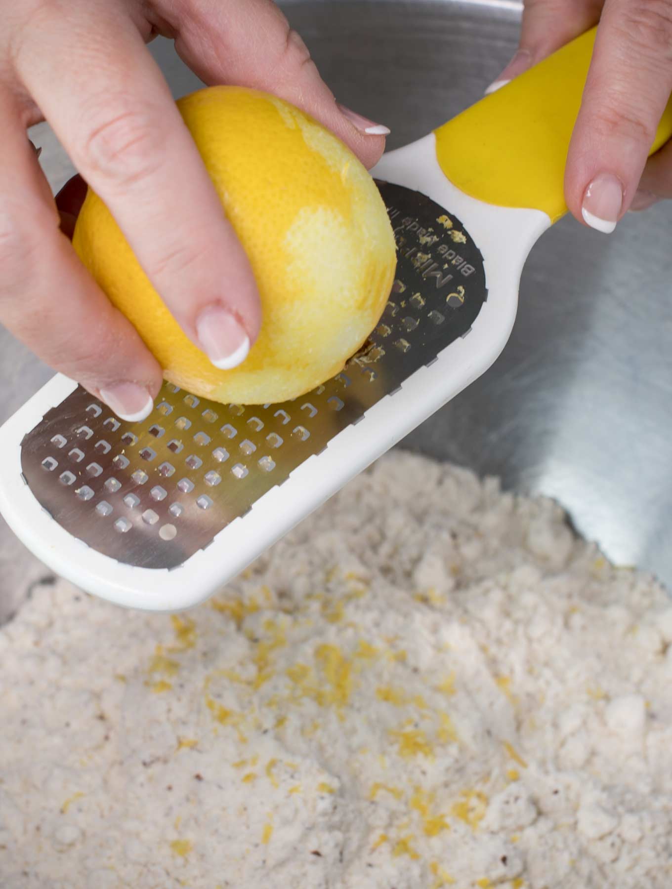Using a zester to zest a lemon