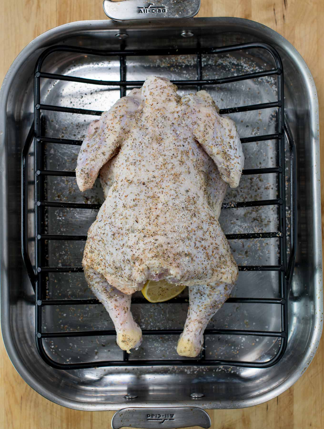 Whole chicken in a roasting pan before cooking