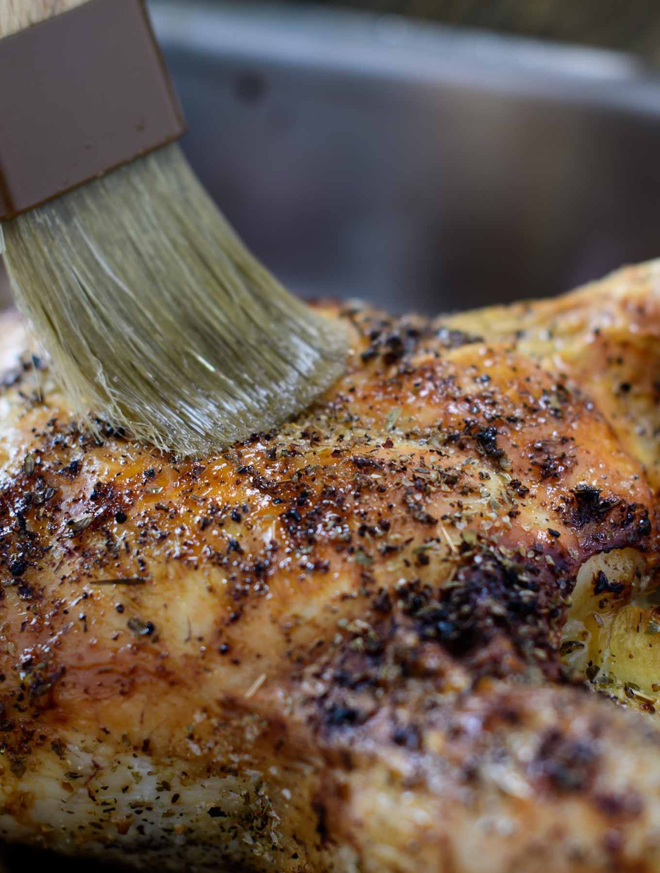 Basting a roasted chicken with white truffle oil