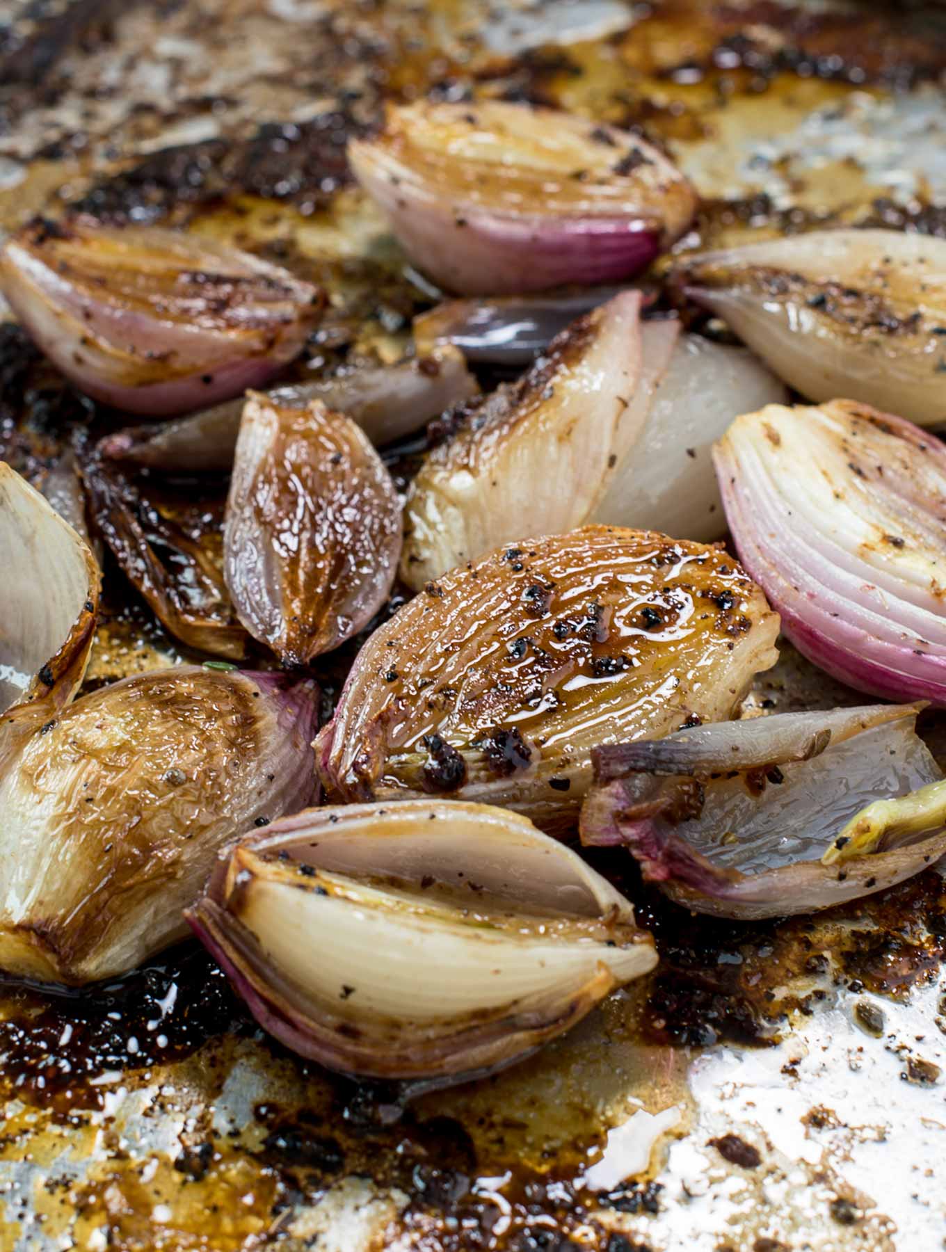 Roasted shallots in a roasting pan