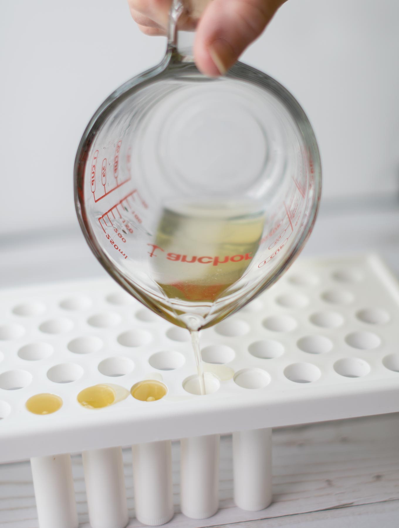 Pouring lip balm into tubes