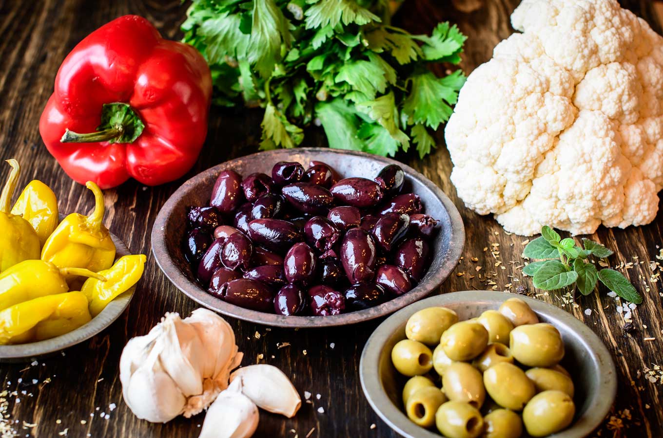 Olive salsa ingredients on wood board