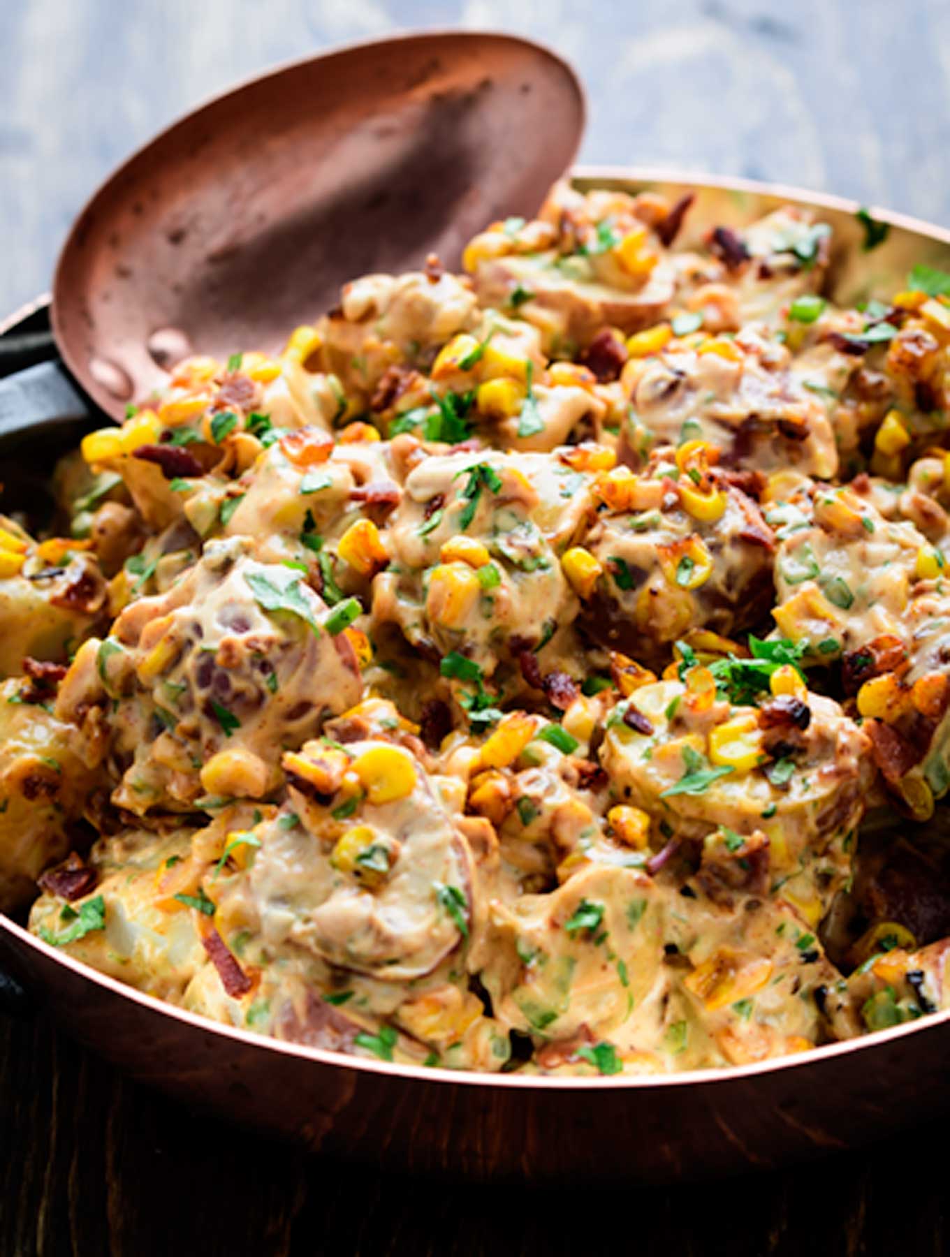 Copper bowl of smoky chipotle potato salad