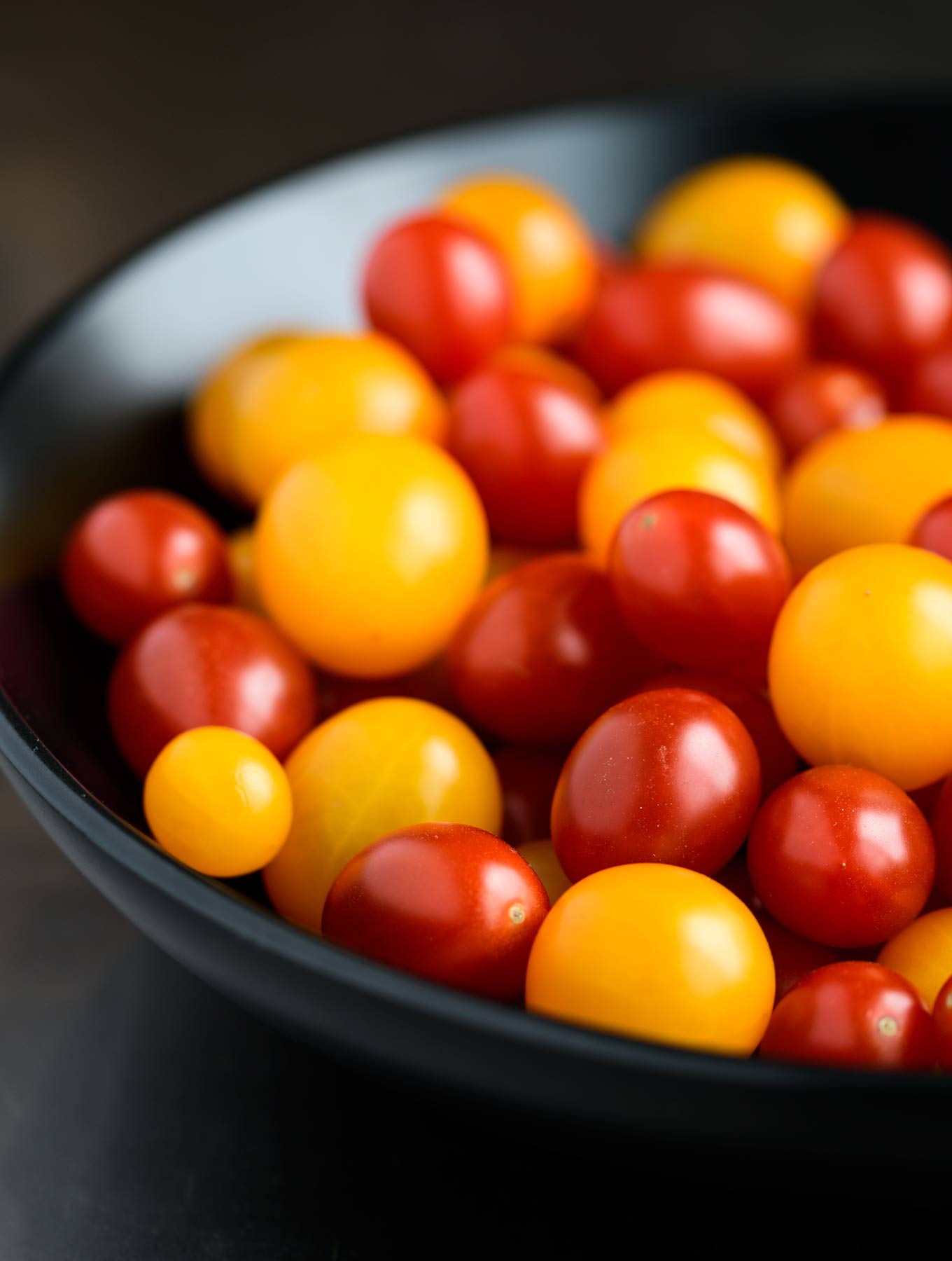 Bowl of yellow and red grape tomatoes