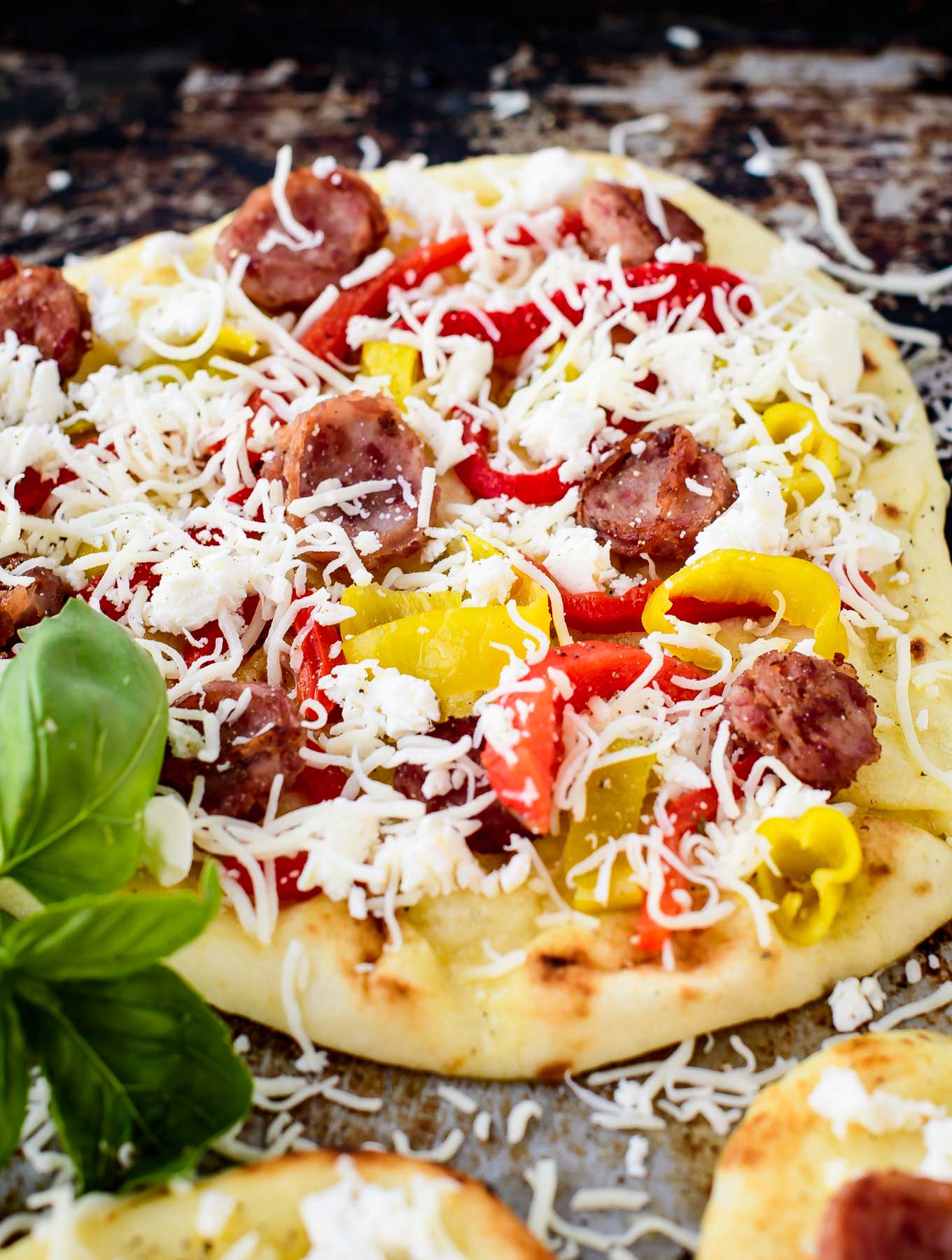 Close up of mediterranean flatbread pizza before baking