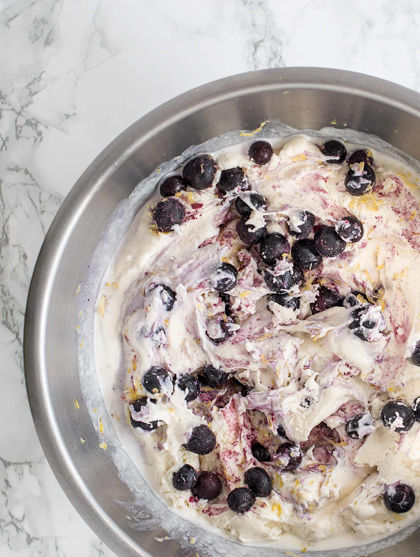 lavender blueberry lemon ice cream in a mixing bowl