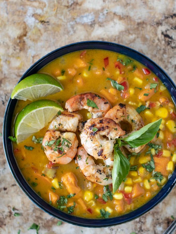 Bowl of corn chowder with shrimp on top