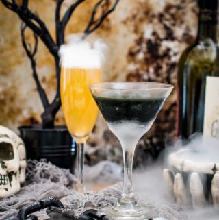 Two halloween cocktails in a spooky scene