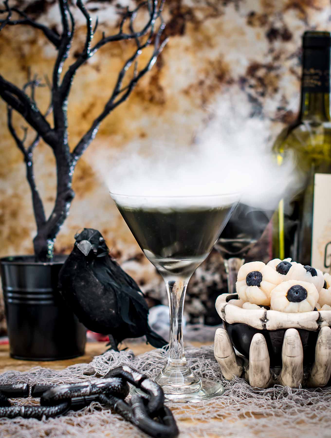 Two halloween cocktails in a spooky scene