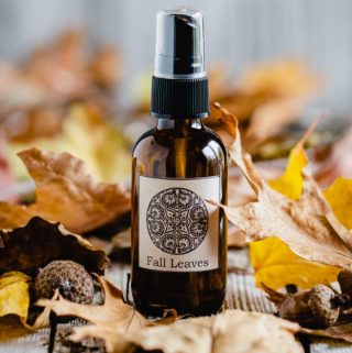 Bottle of fall room spray with leaves