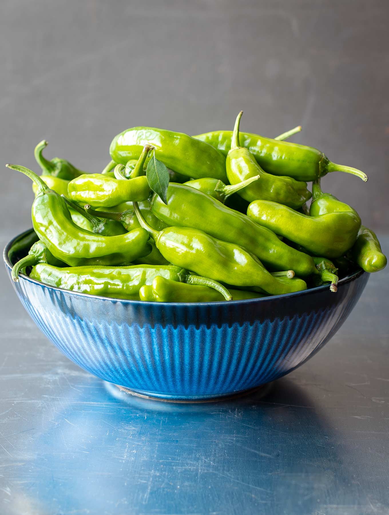 Blue bowl of shishito peppers