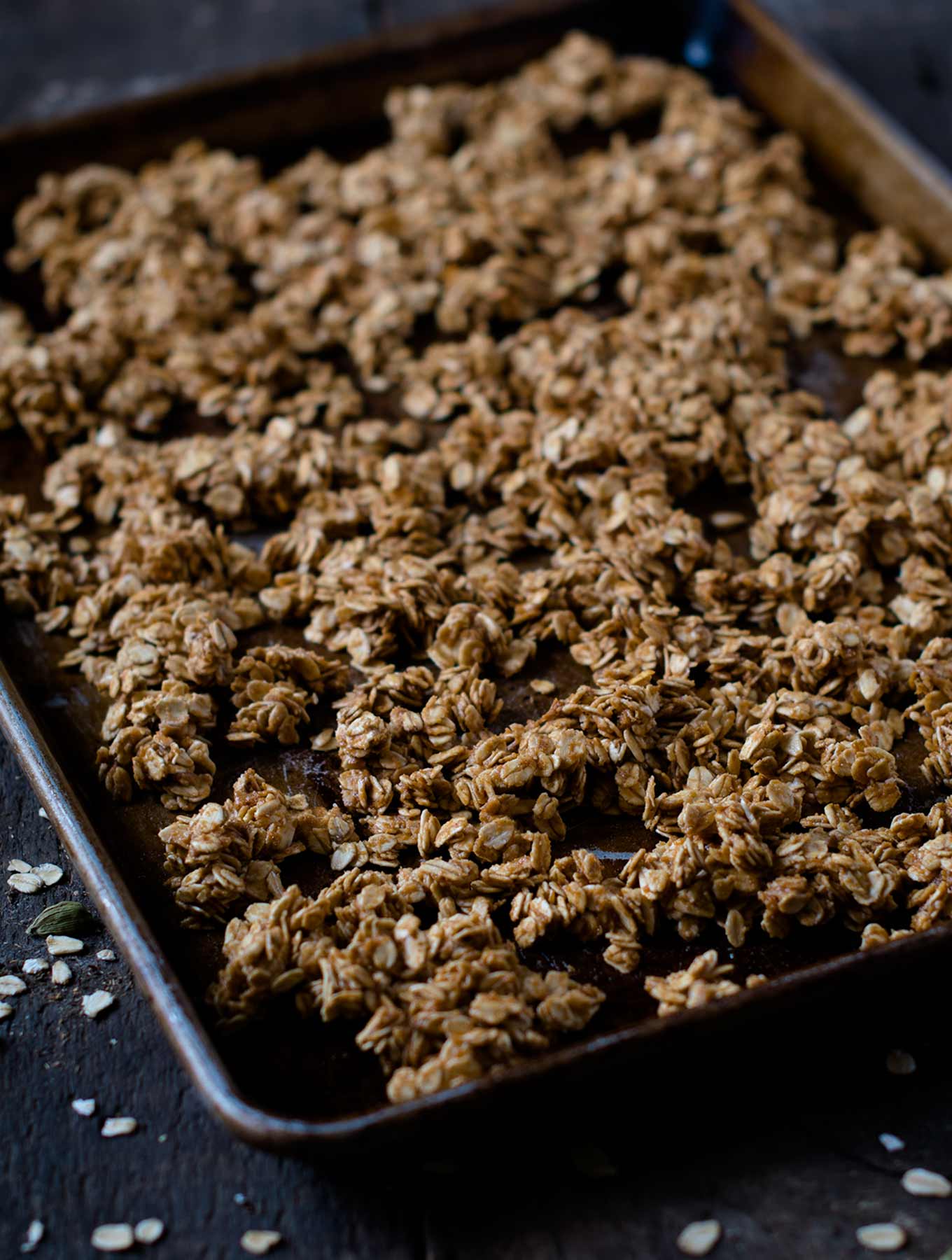 Maple cardamom granola on a baking sheet