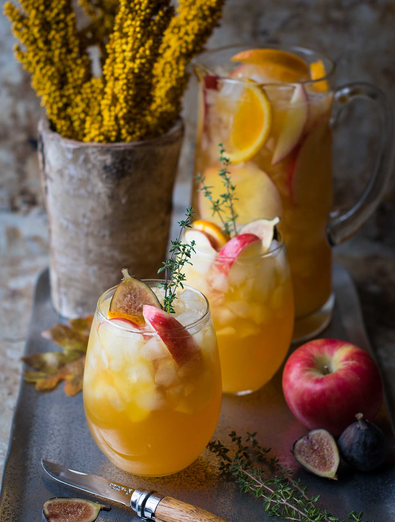 two glasses of Fall harvest sangria and a pitcher