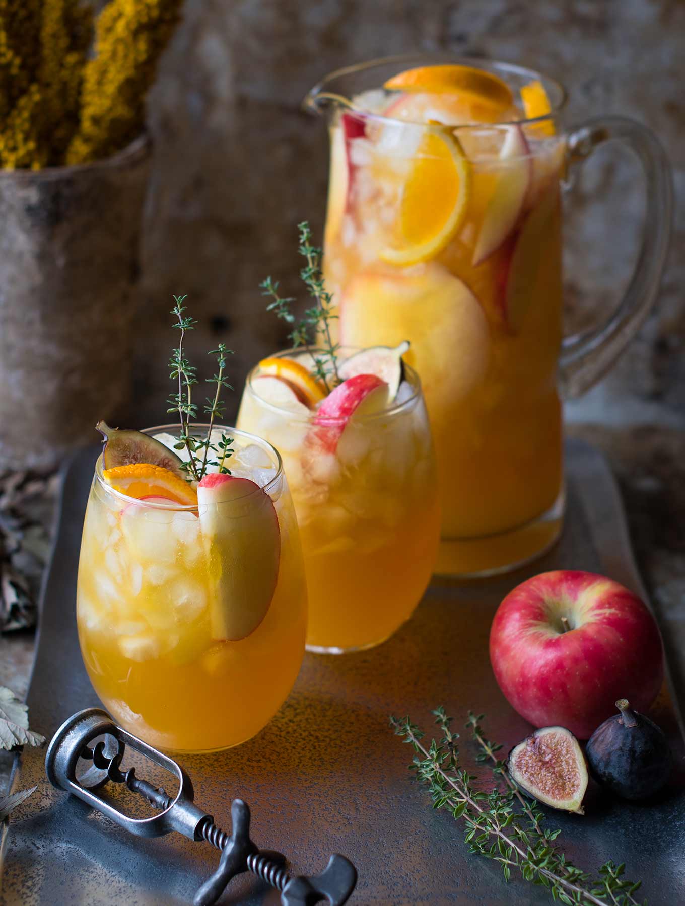 two glasses of Fall harvest sangria and a pitcher