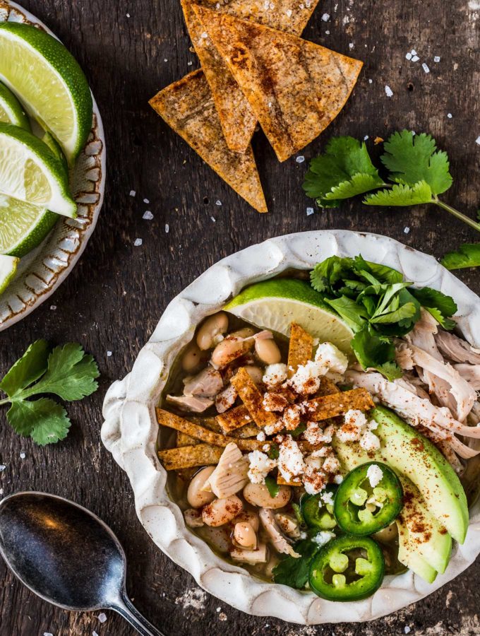 Bowl of green chili chicken soup with toppings