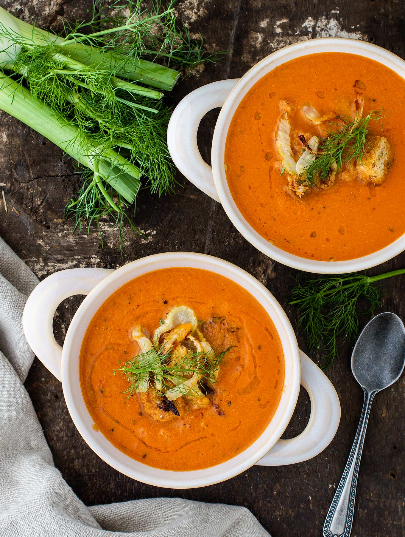 Two bowls of creamy tomato fennel soup