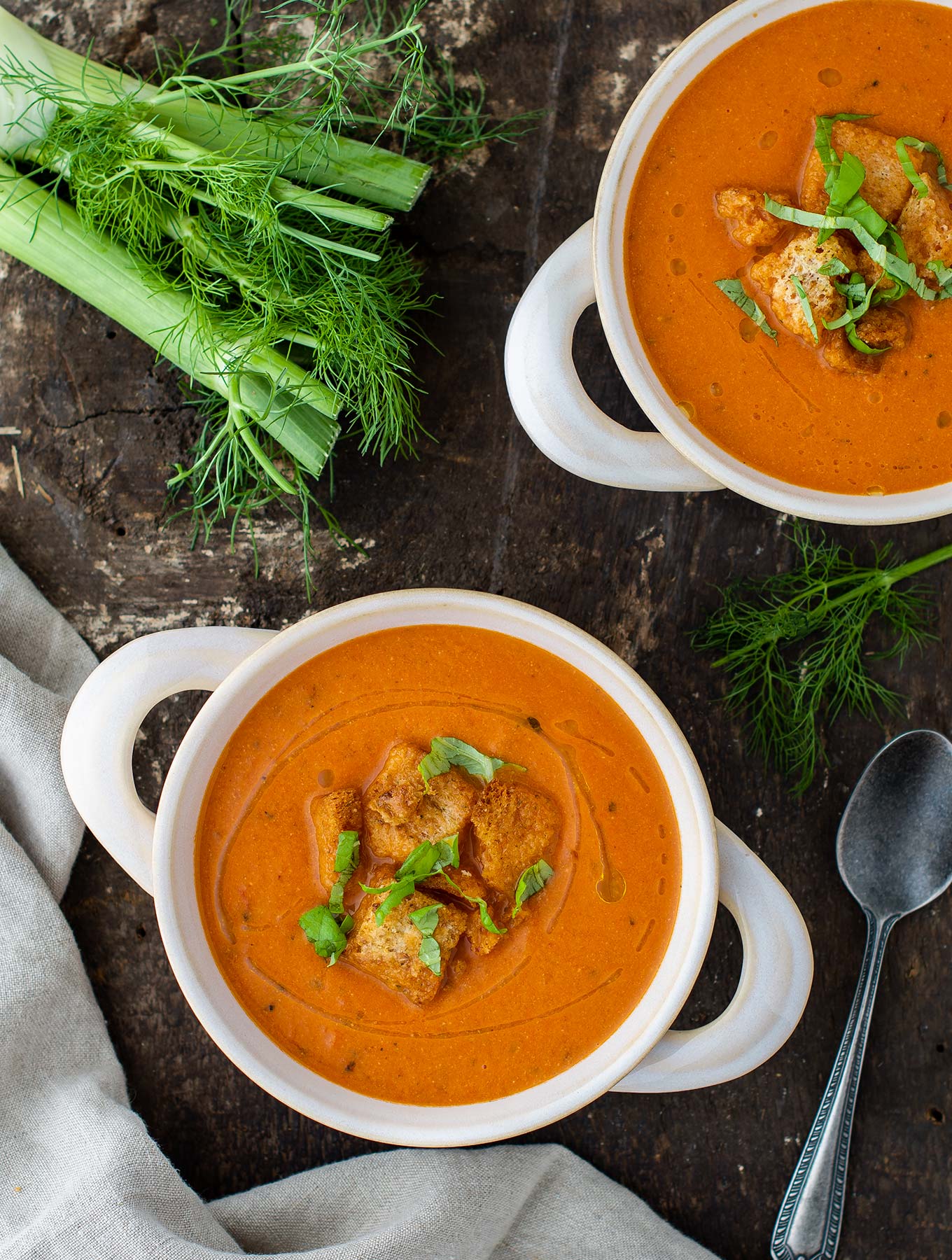 Two bowls of creamy tomato fennel soup