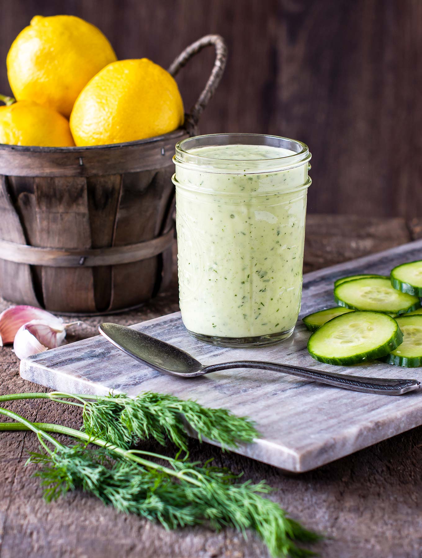 Jar of tzatziki dressing on a marble slab