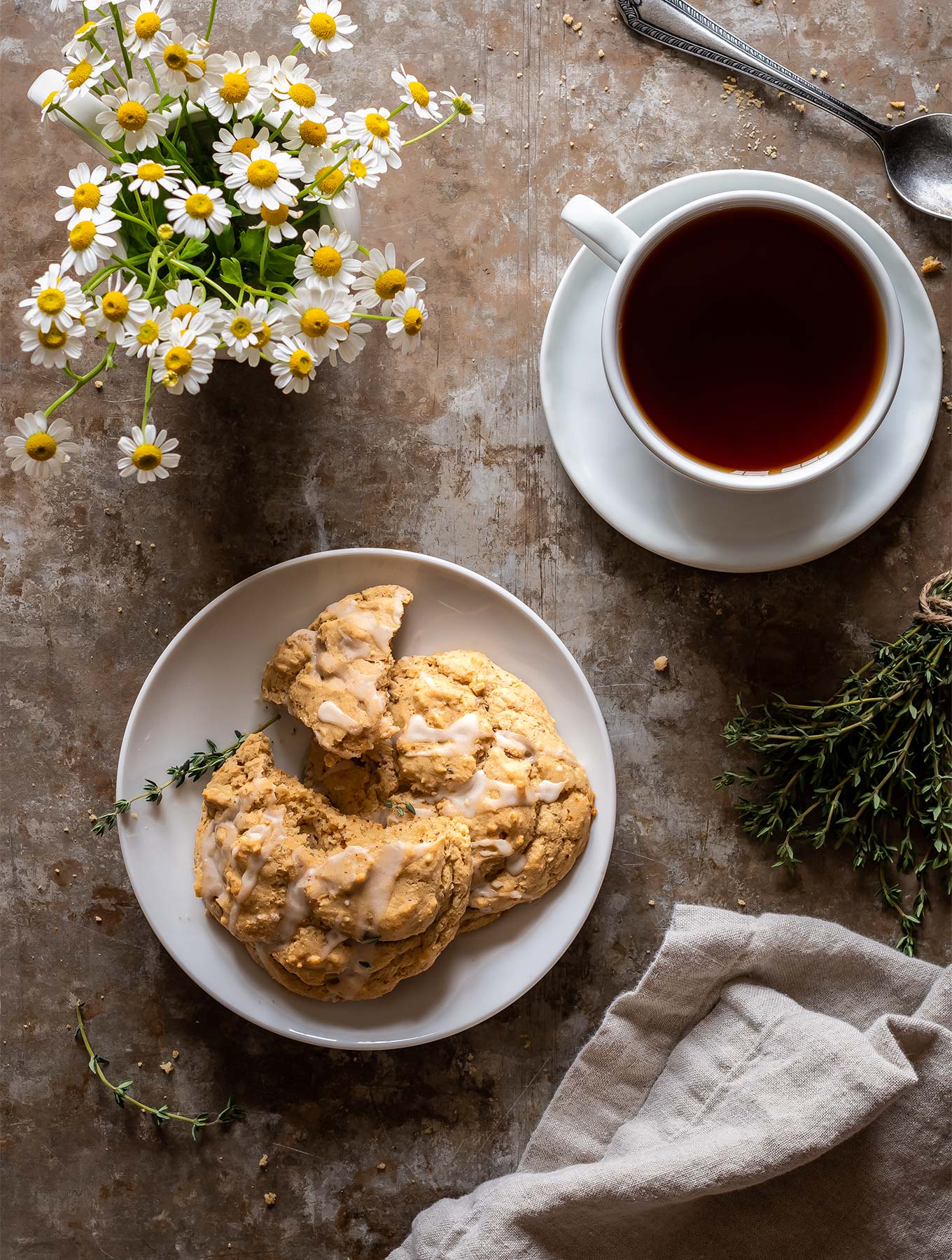 Overhead lemon thyme scones with a cup of tea and flowers