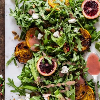 overhead picture of arugula salad with goat cheese and golden beets
