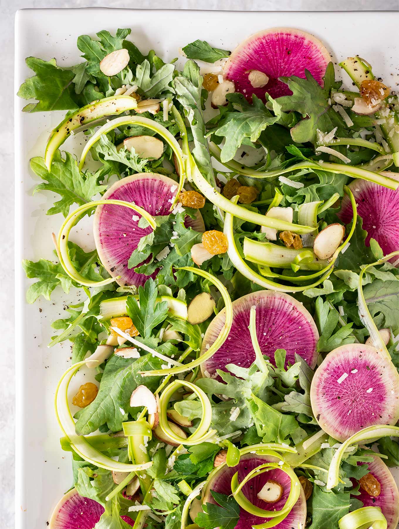 Plate of shaved asparagus salad and watermelon radish