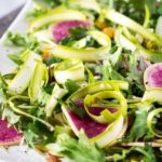 Plate of shaved asparagus salad and watermelon radish