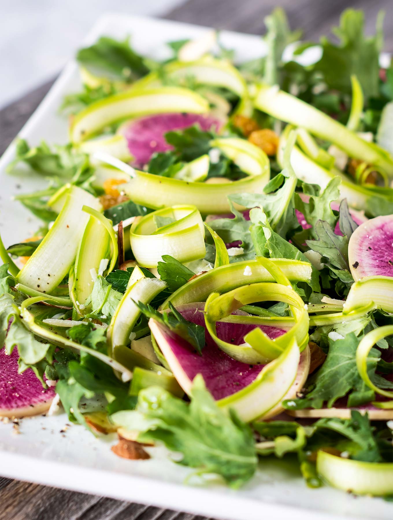 Plate of shaved asparagus salad and watermelon radish