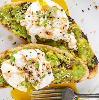 Two pieces of avocado toast on grilled bread