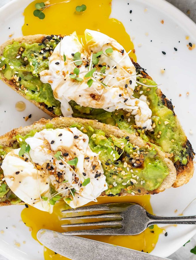Two pieces of avocado toast on grilled bread
