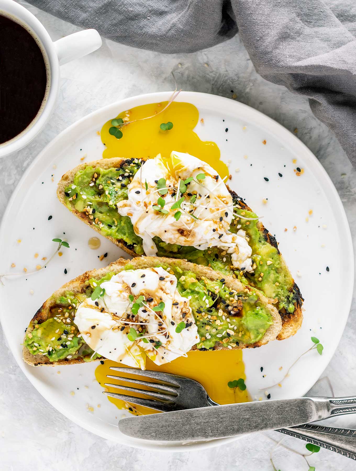 Two pieces of avocado toast on grilled bread