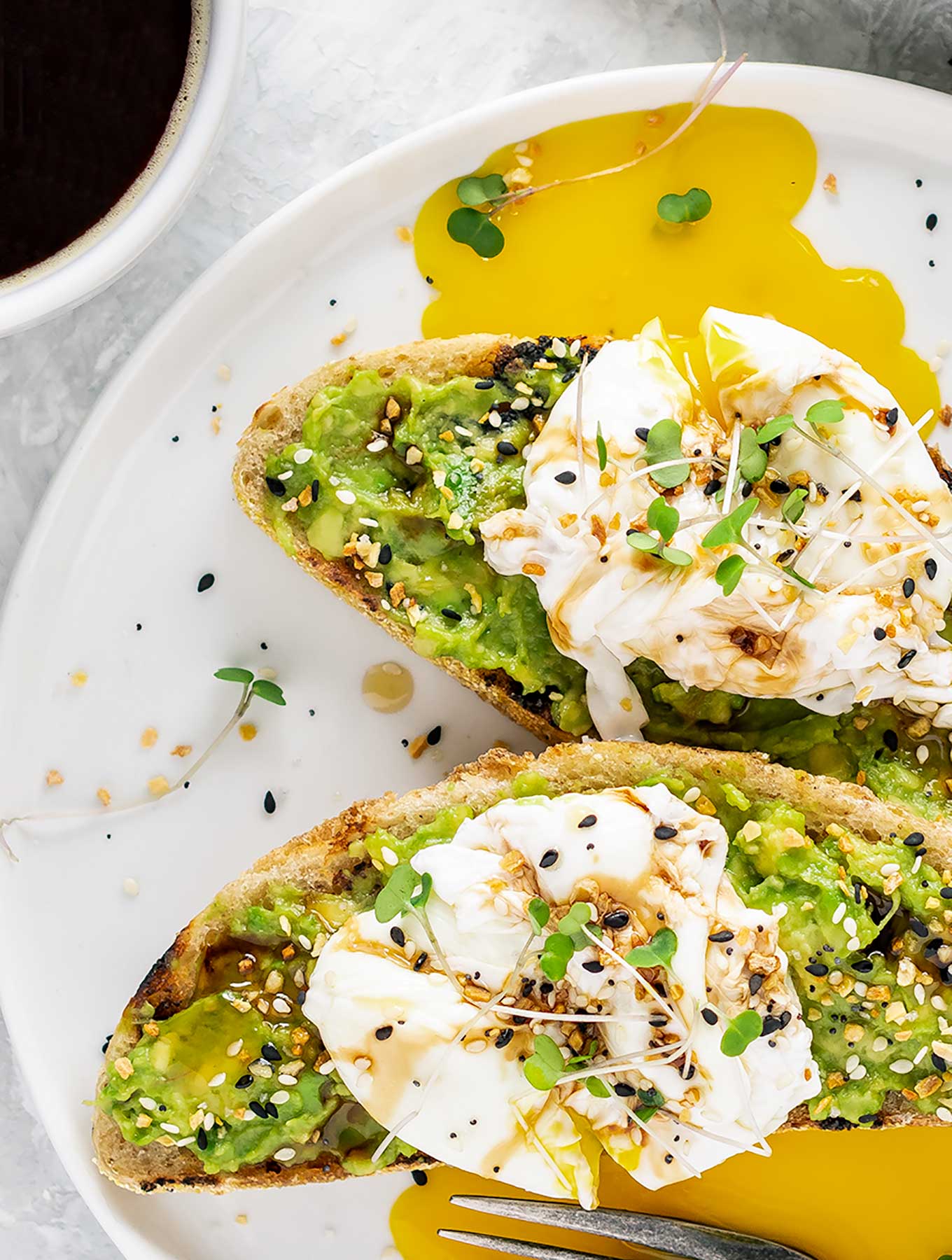 Two pieces of avocado toast on grilled bread