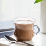 close up of clear mug of cardamom cashew latte