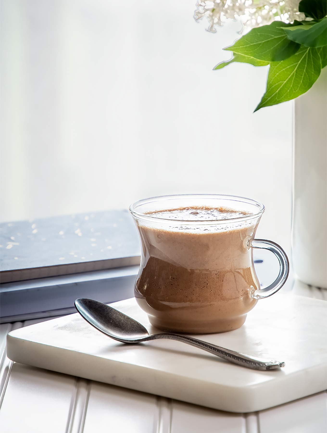 clear mug of cardamom cashew latte