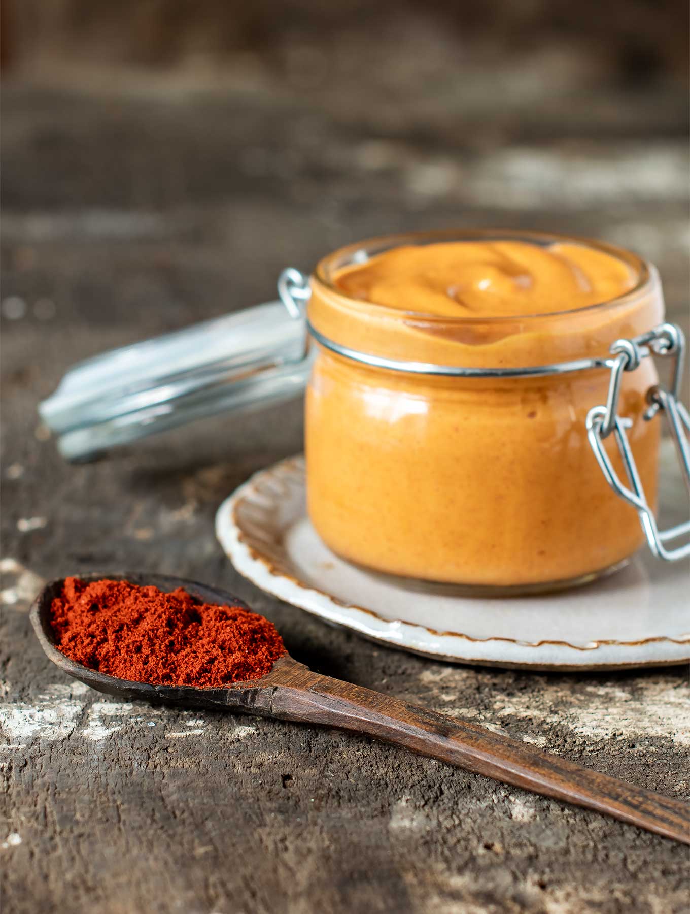 Jar of smoked paprika aioli with spoon of smoked paprika