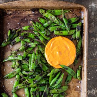 Tray of grilled snap peas with smoked paprika aioli