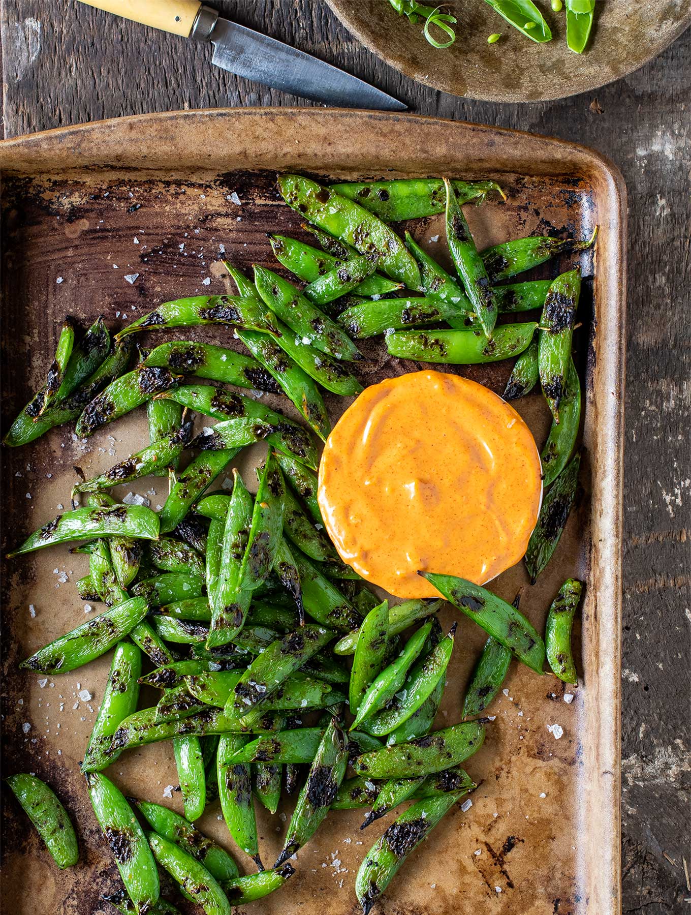 Tray of grilled snap peas with smoked paprika aioli