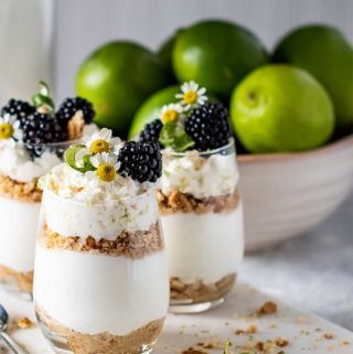 Three glasses of key lime pie parfaits on a marble square