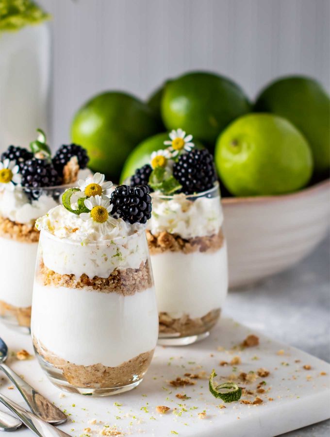 Three glasses of key lime pie parfaits on a marble square