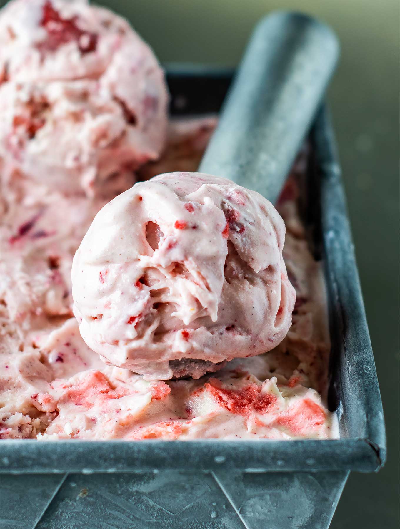 Close up of strawberry rose ice cream in an ice cream scoop