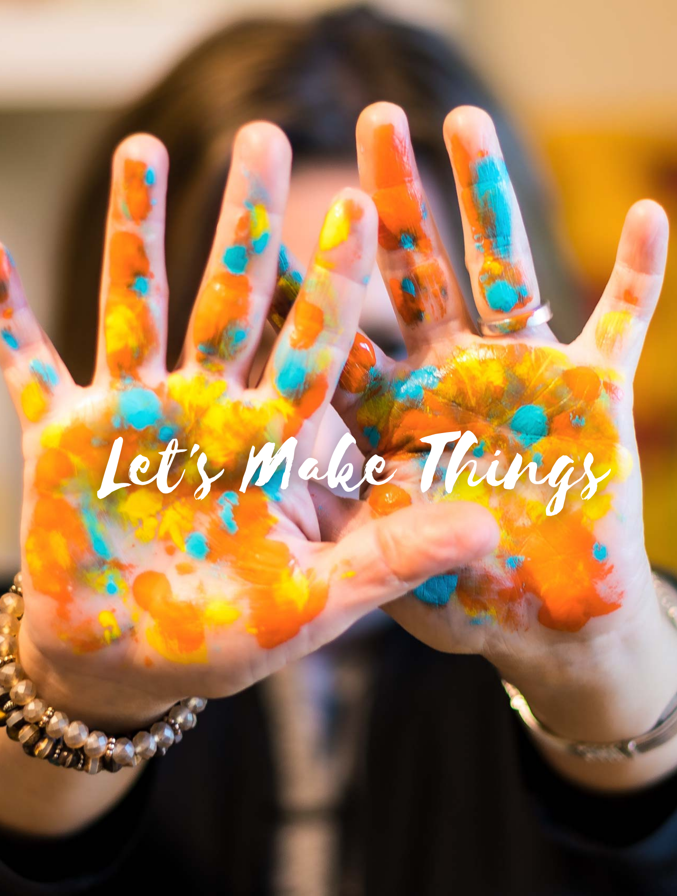 Painted hands with the words "let's make things"