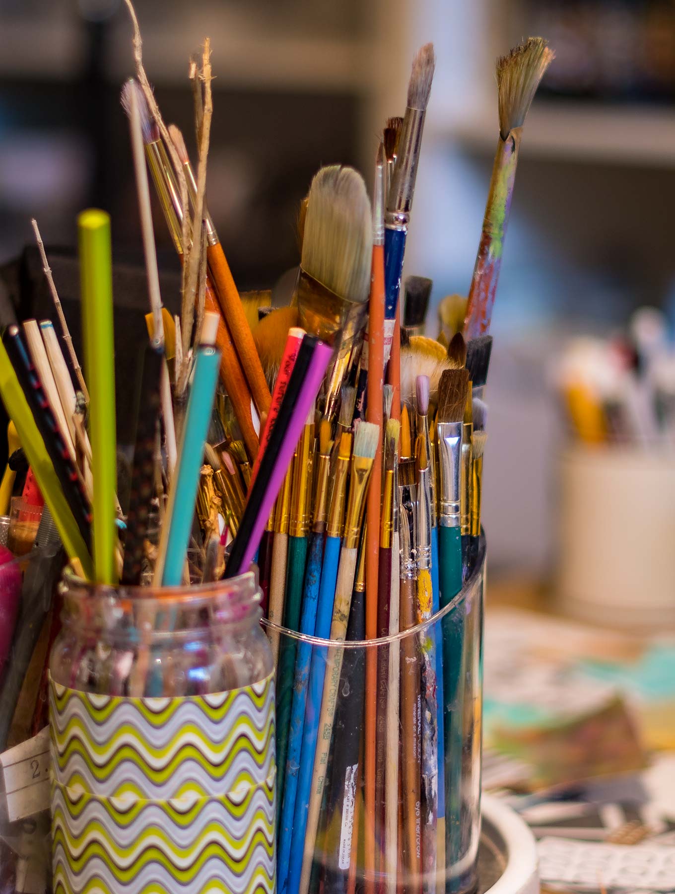 Two jars of paint brushes